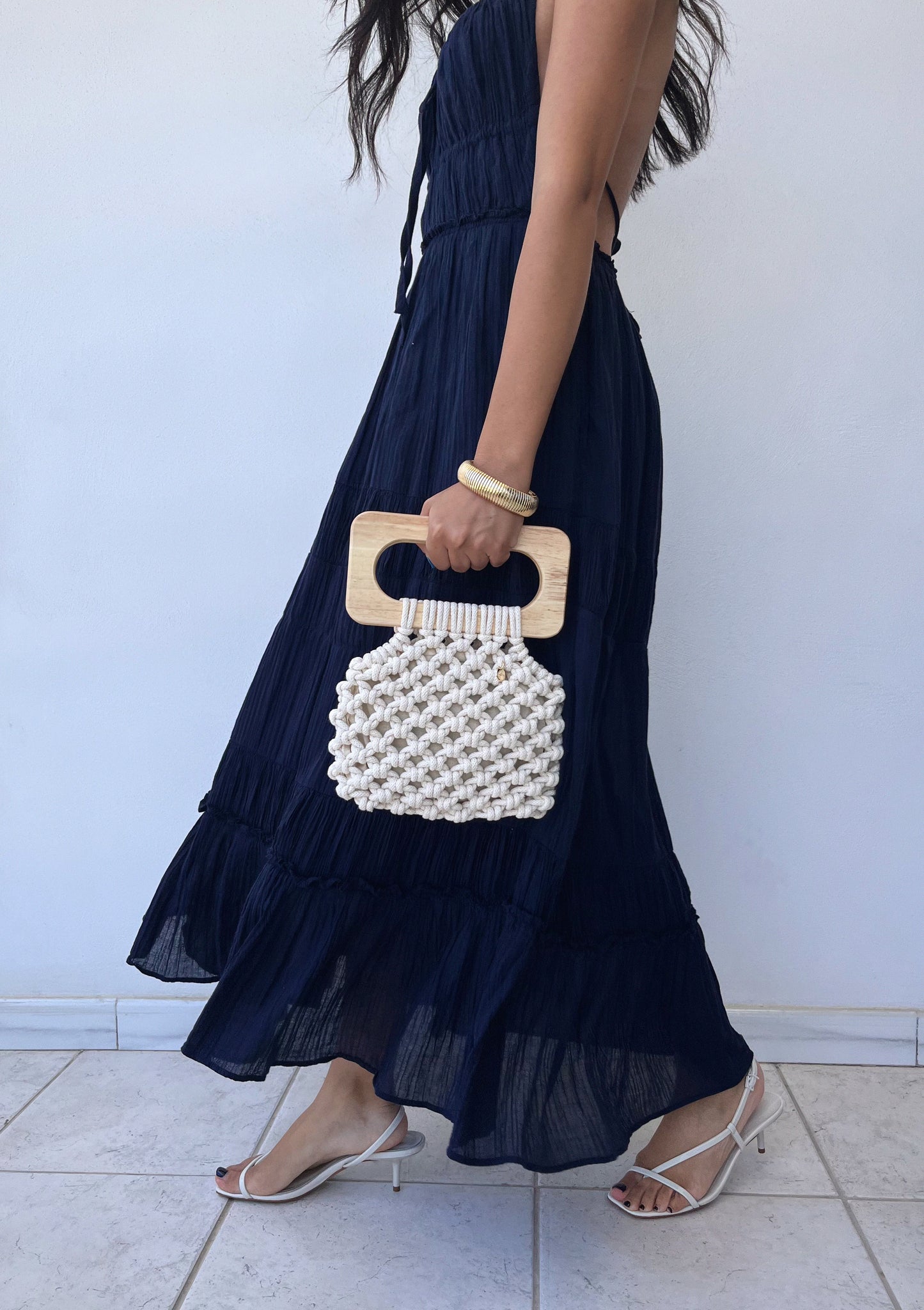 Handmade Koma Bag in Natural styled with a navy blue dress and heeled sandals.