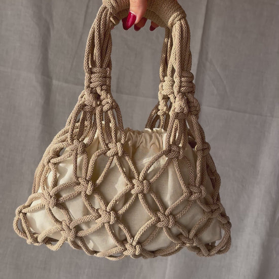 holding the sian bag macrame bag